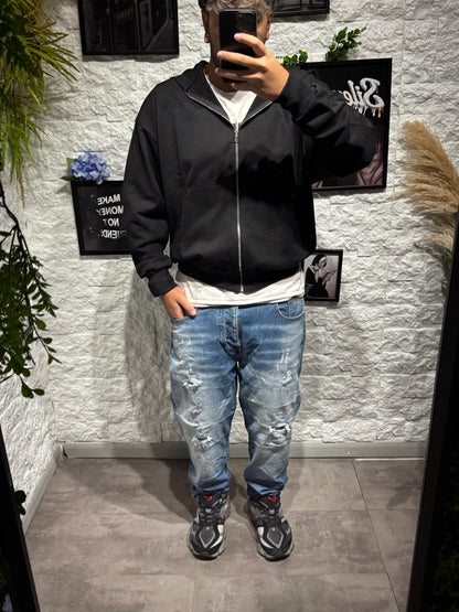 Jeans tapered blu in denim con strapp