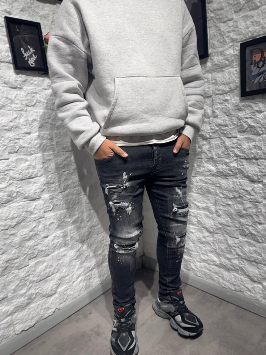 Jeans skinny grigio scuro in denim con schizzi di vernice