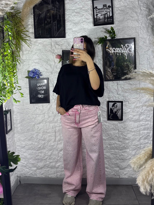 Jeans rosa slavato in denim con strass e vita asimmetrica