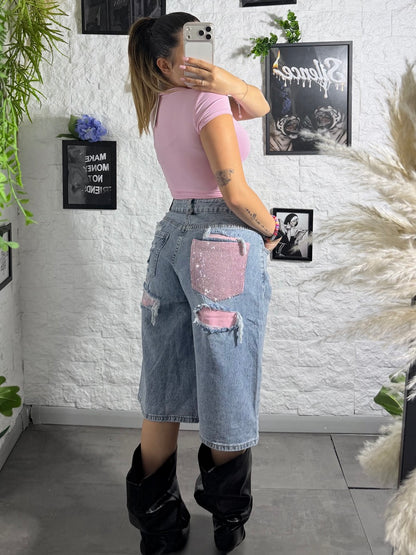 Jeans jort denim chiaro con tasca rosa brillantinata