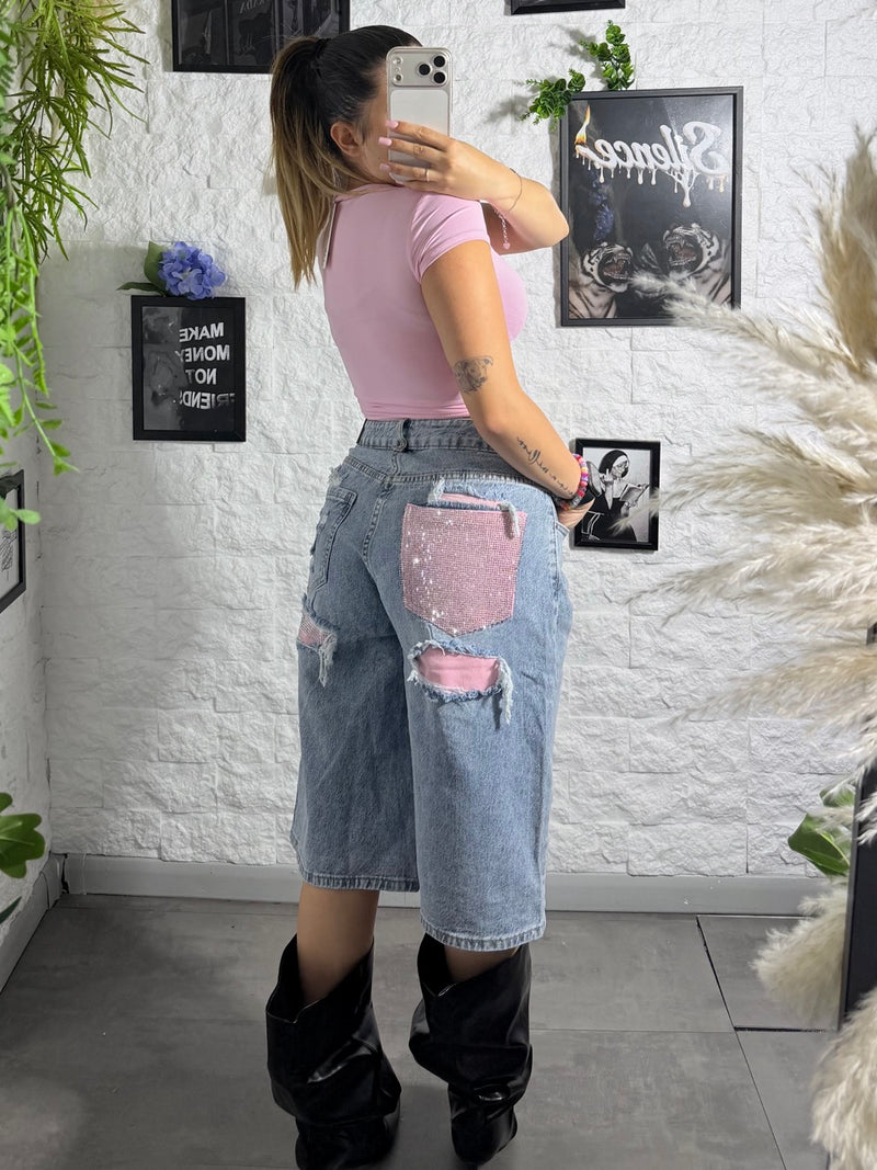 Jeans jort denim chiaro con tasca rosa brillantinata