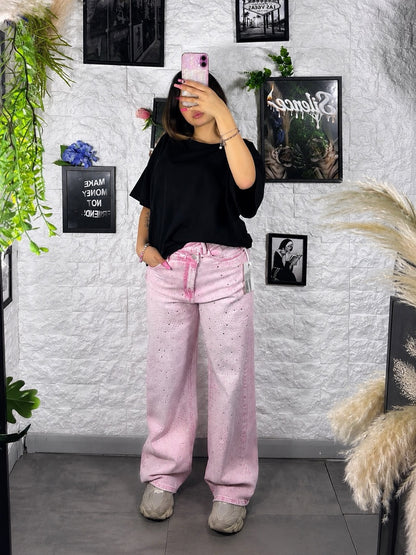 Jeans rosa slavato in denim con strass e vita asimmetrica